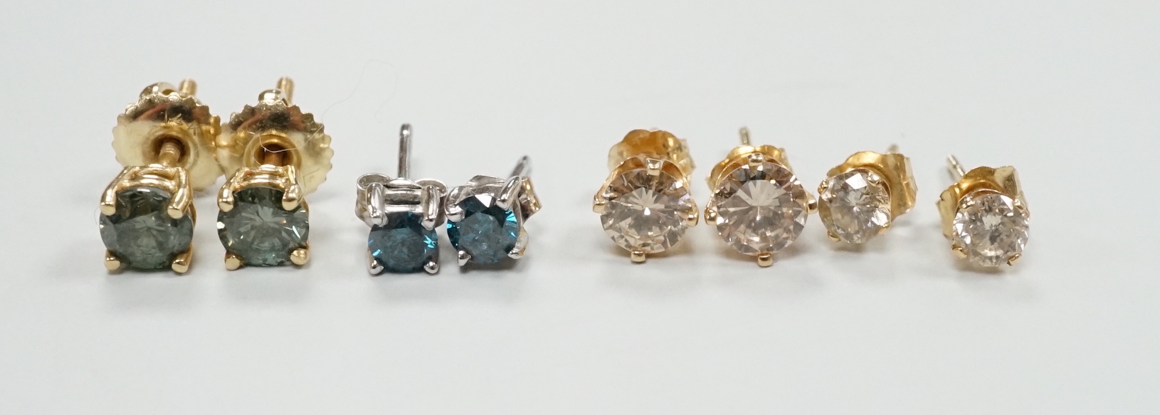 Four assorted pairs of yellow or white metal and diamond set ear studs, including coloured stones.